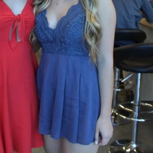 cute gray/ blue colored romper, crosses in back! Size XS from Lulu’s